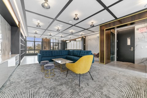 a living room with a blue couch and a yellow chair